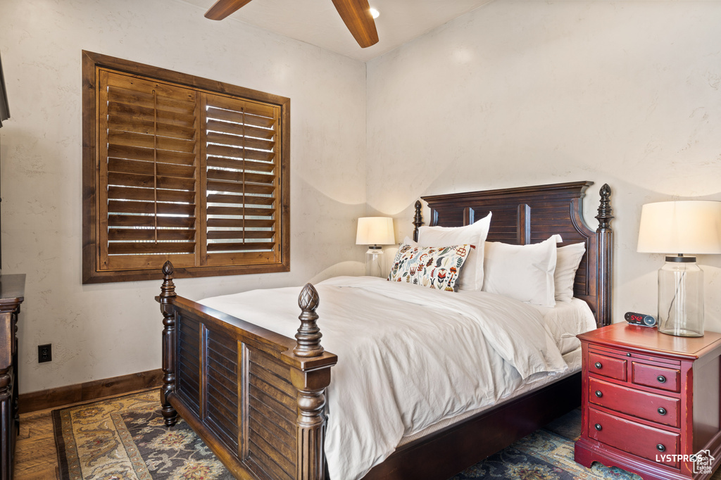 Bedroom featuring baseboards, ceiling fan, and wood finished floors