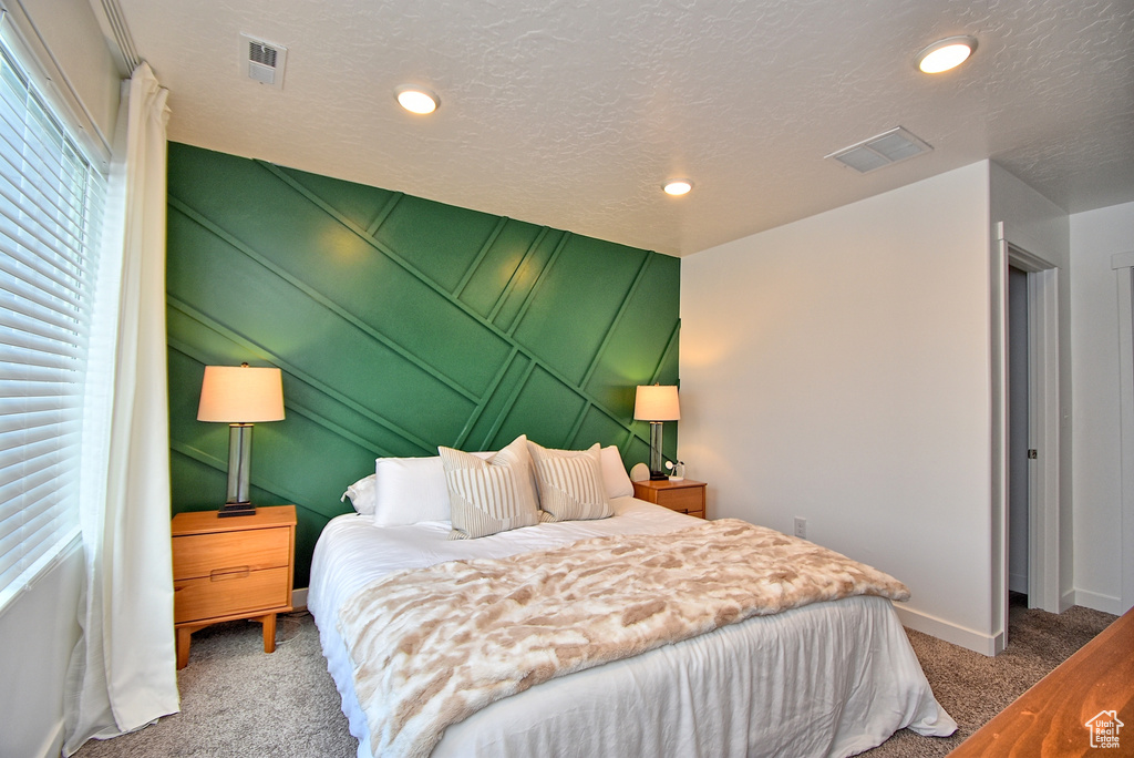 Carpeted bedroom with baseboards and recessed lighting