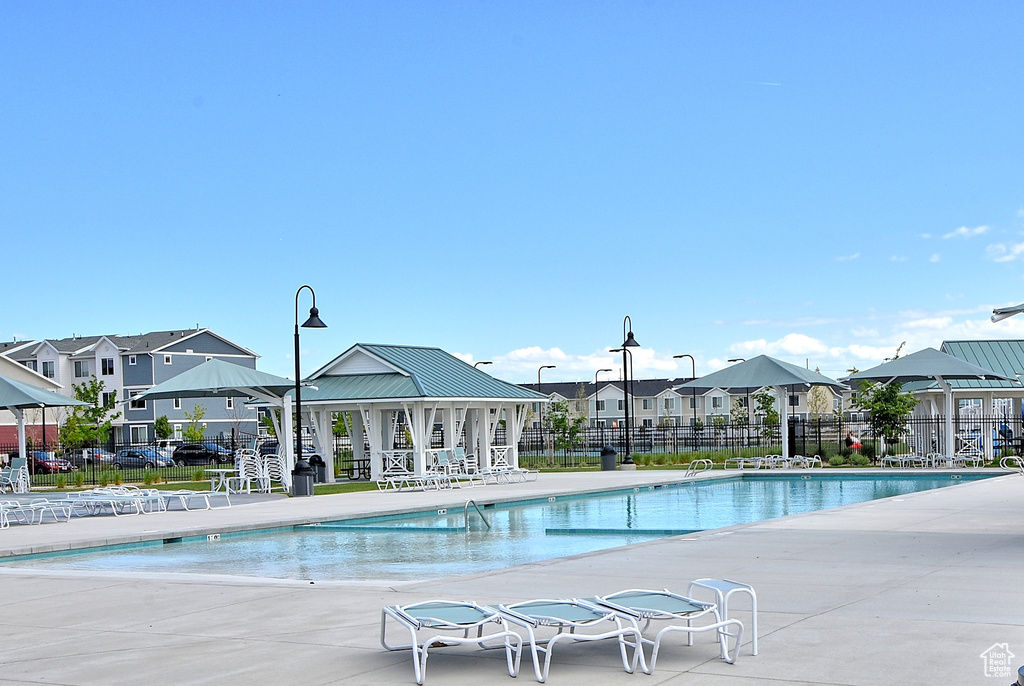 Community pool with a residential view and a patio