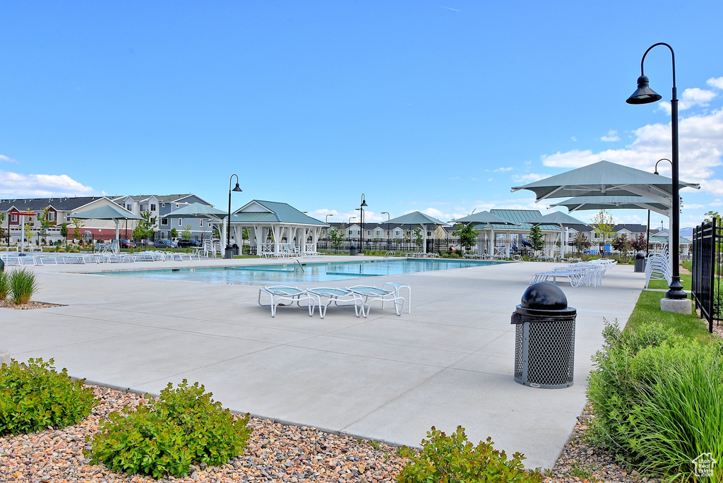 Community pool with a residential view and a patio