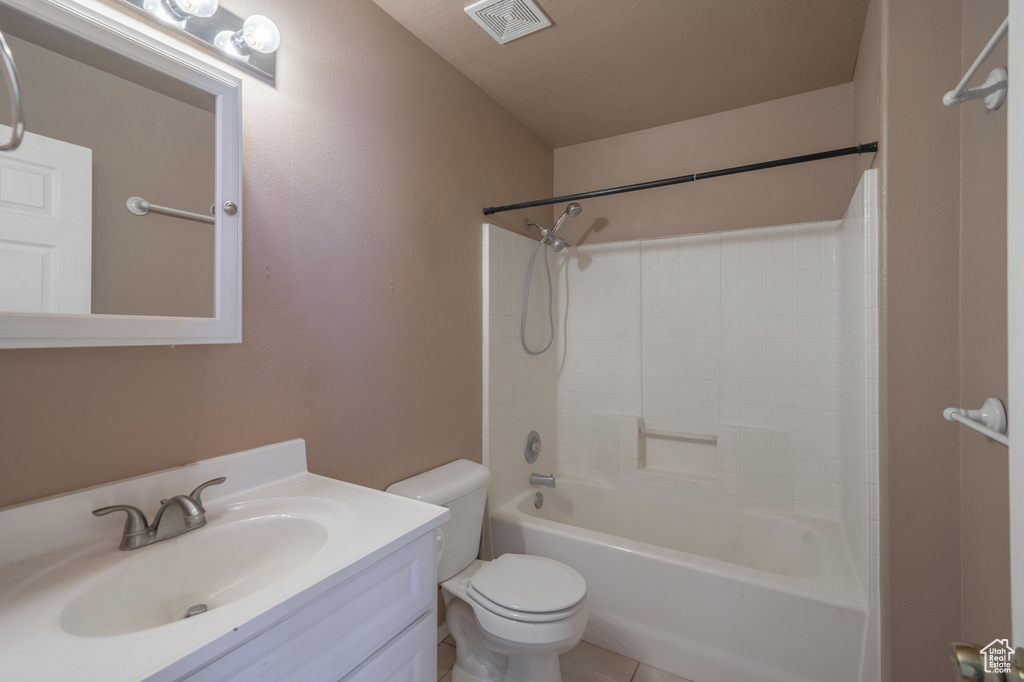 Full bath featuring toilet, vanity, and shower / washtub combination