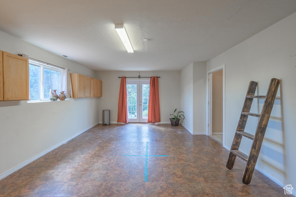 Empty room with tile patterned floors and baseboards