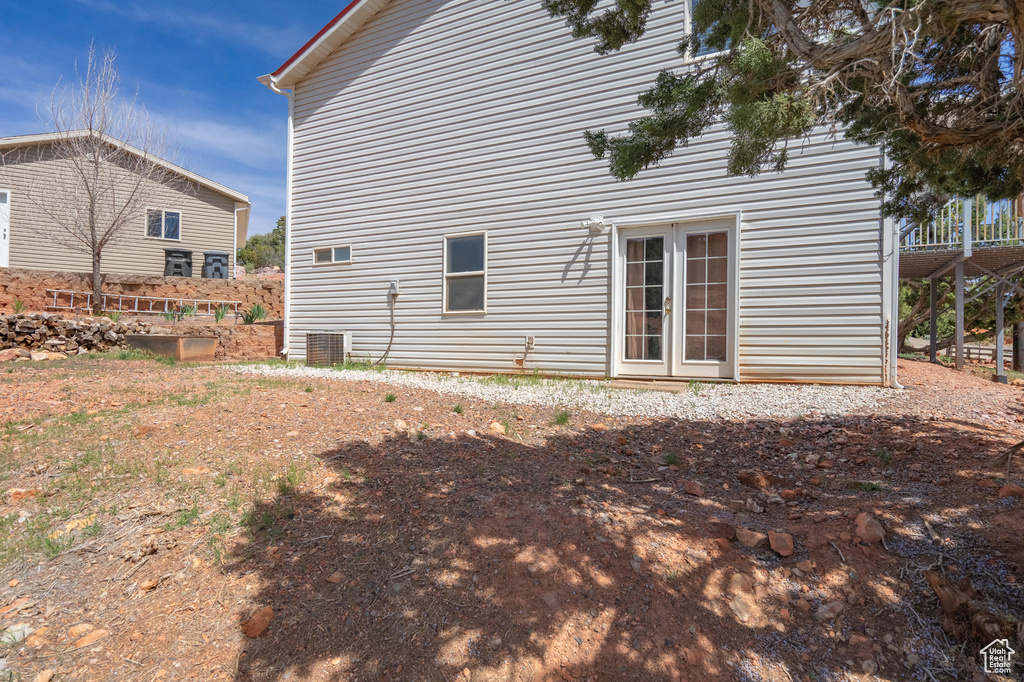 Rear view of property featuring cooling unit