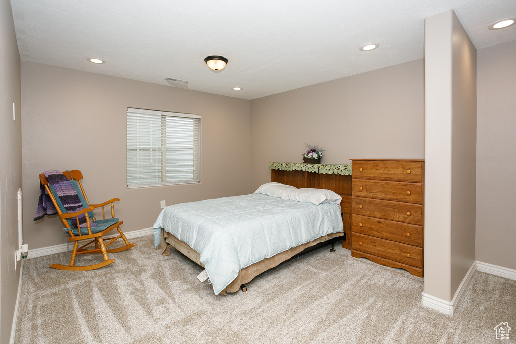 Bedroom with carpet flooring, baseboards, and recessed lighting