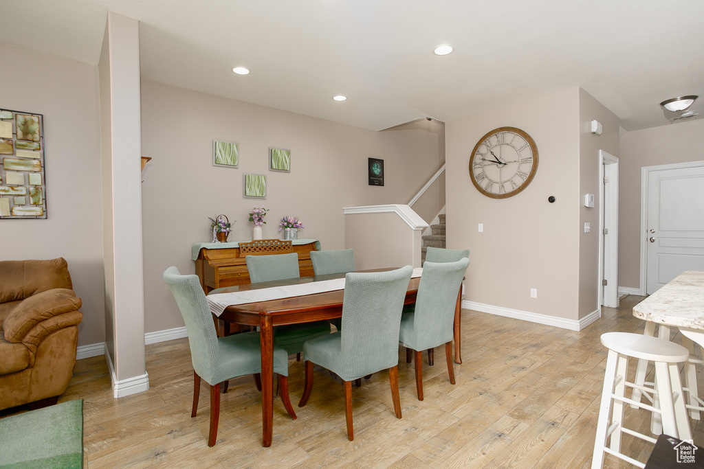 Dining room featuring light wood-style floors, stairway, recessed lighting, and baseboards