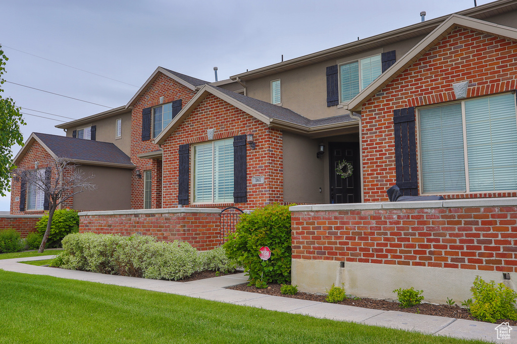 Traditional-style house with stucco siding and brick siding