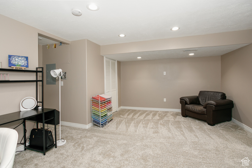 Sitting room featuring light colored carpet, baseboards, and recessed lighting