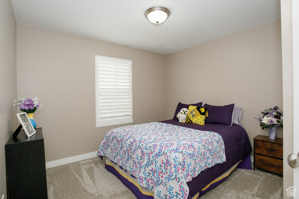 Carpeted bedroom with baseboards