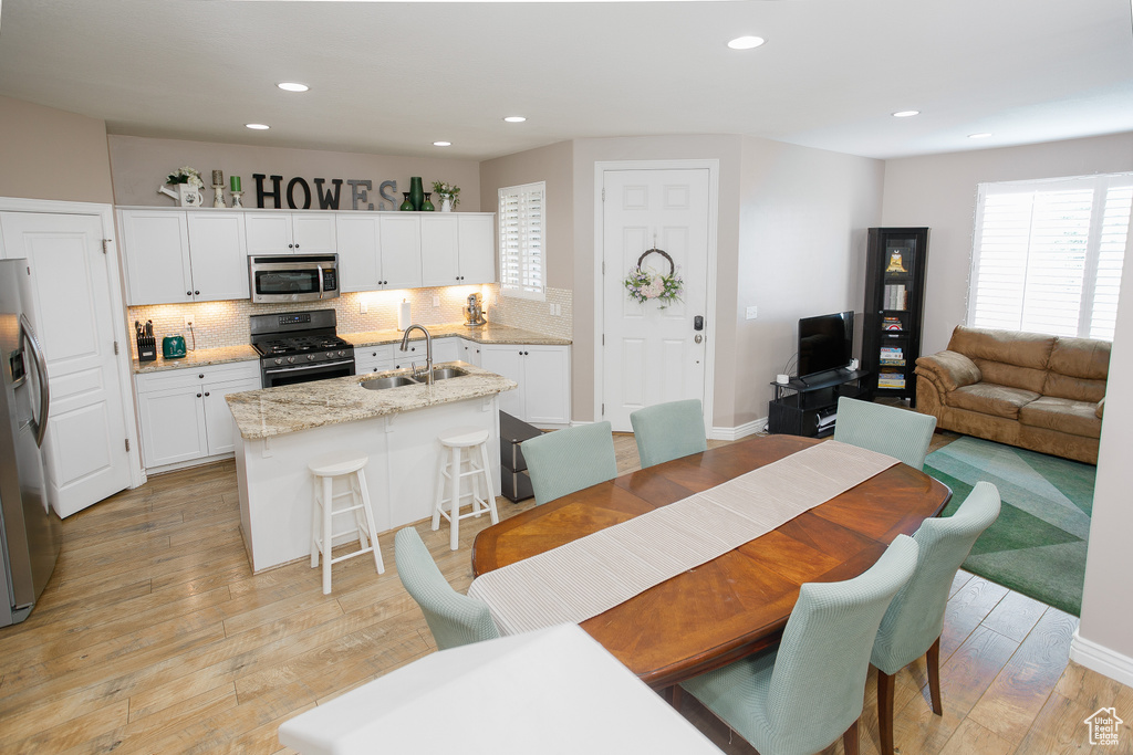 Dining room featuring recessed lighting and light wood-type flooring