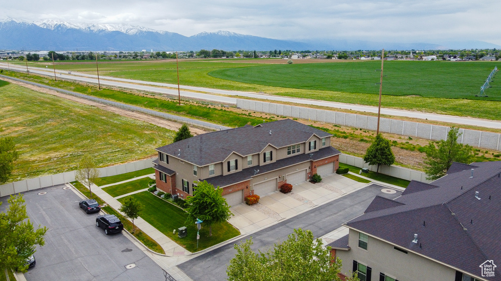 Aerial view of property and surrounding area featuring mountains