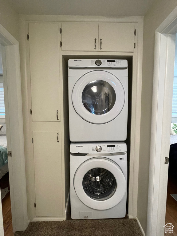 Washroom featuring stacked washer / dryer and baseboards