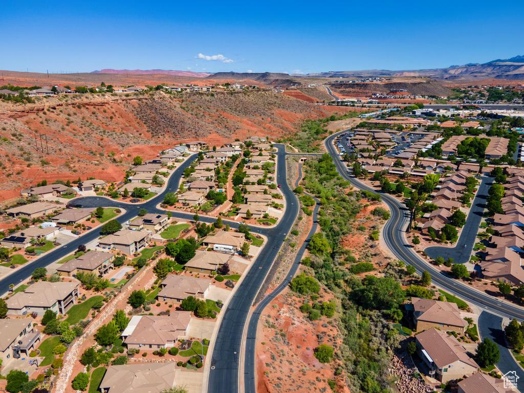 Aerial overview of property's location featuring a mountain backdrop and nearby suburban area