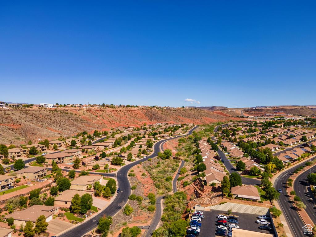 Aerial view of property's location featuring a mountain backdrop and nearby suburban area