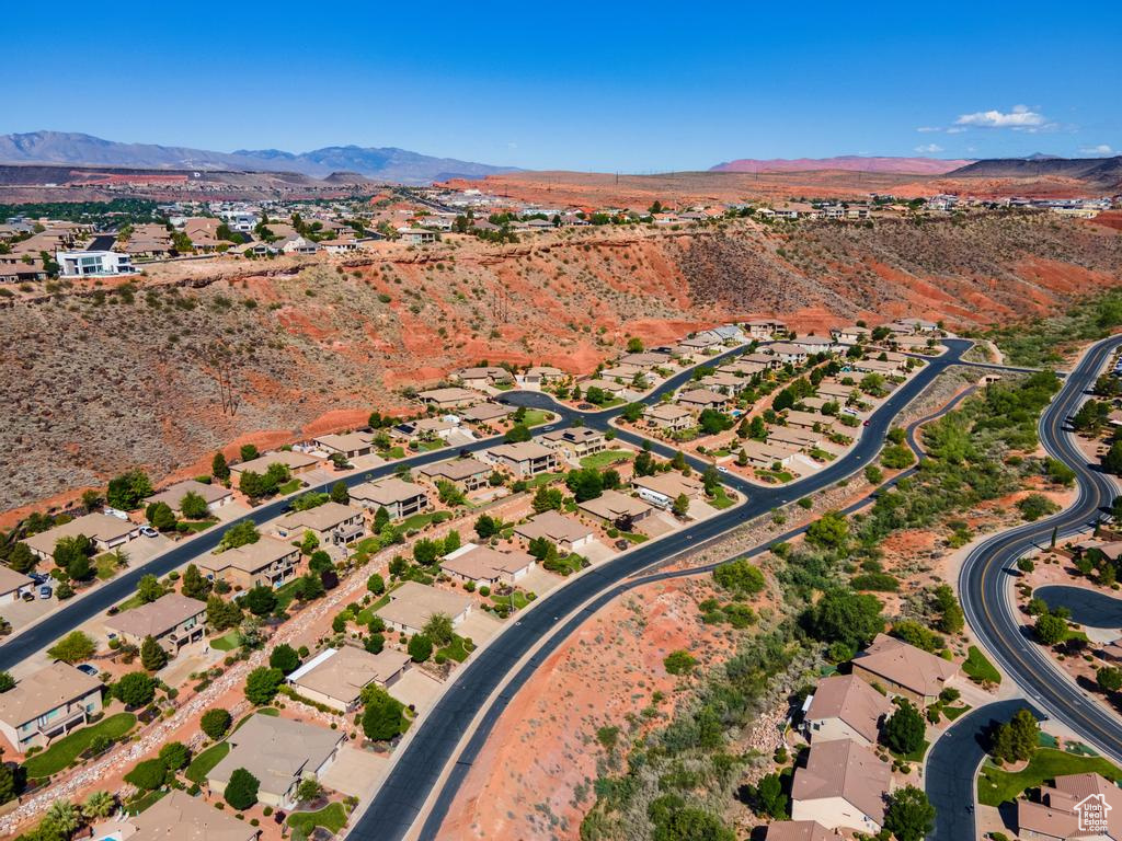 Aerial view of property and surrounding area with mountains and nearby suburban area