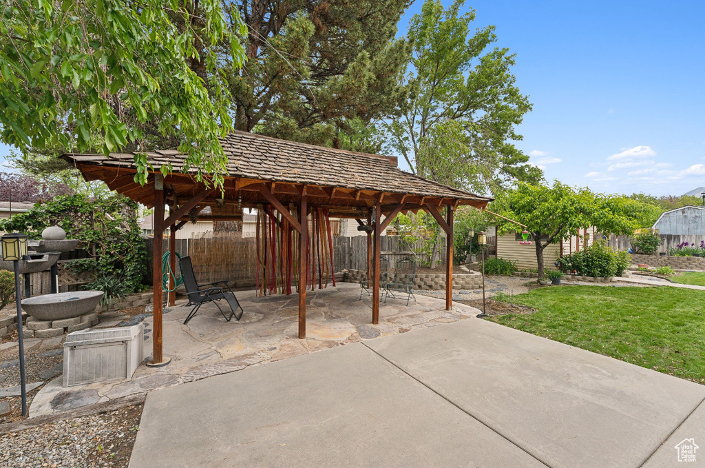 View of patio featuring a gazebo and an outbuilding