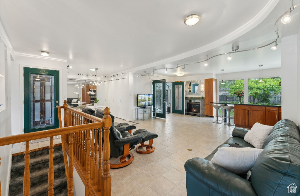 Living room featuring a lit fireplace and rail lighting
