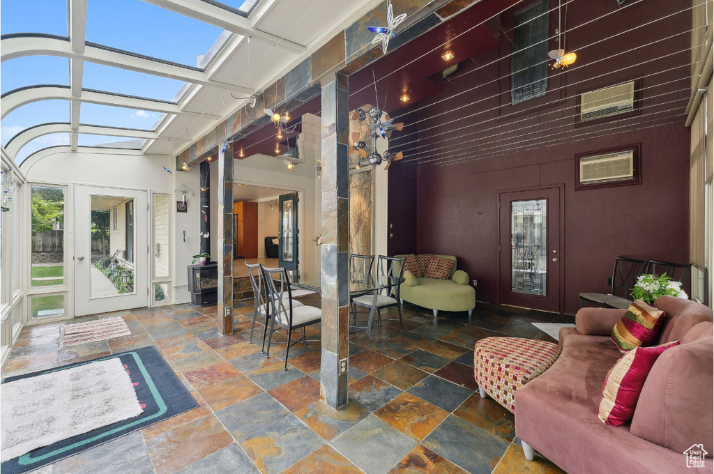 Sunroom / solarium with a wood stove and french doors