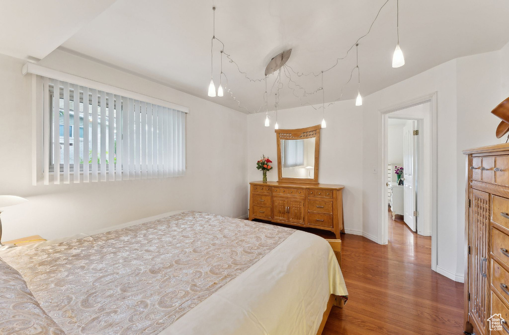 Bedroom with wood finished floors and baseboards