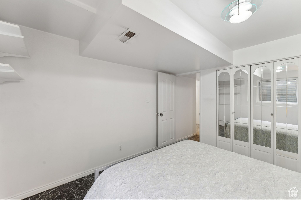 Bedroom featuring marble finish floors and baseboards