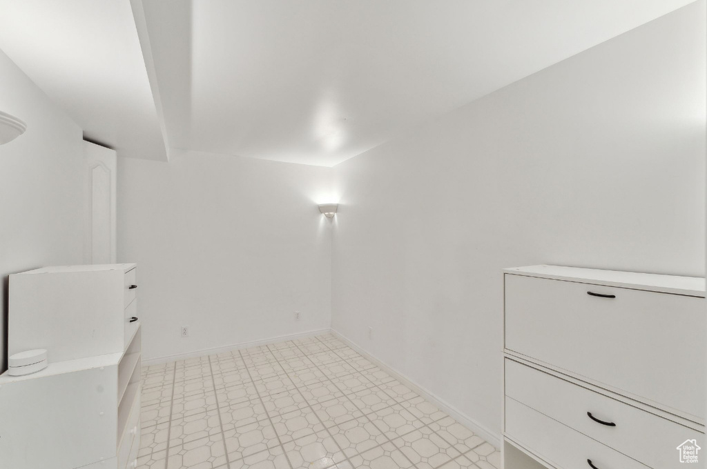 Unfurnished room with light flooring and baseboards