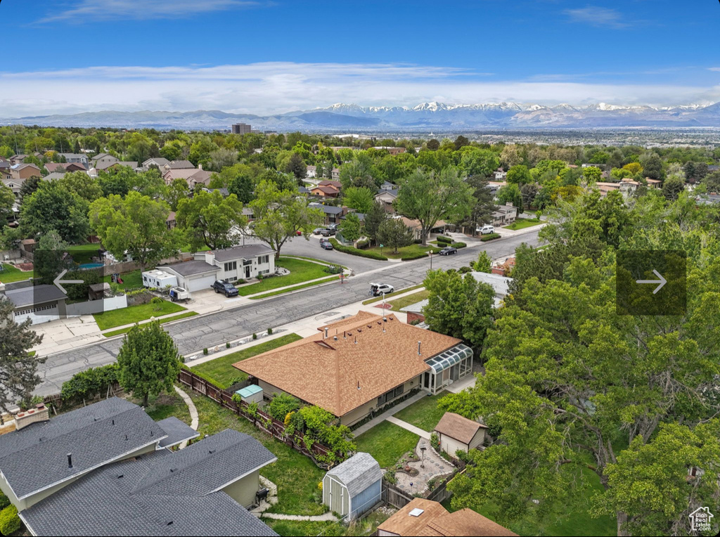 Aerial perspective of suburban area featuring a mountainous background
