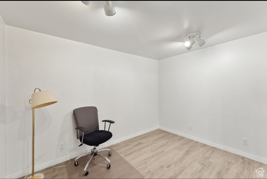 Unfurnished room with wood finished floors and baseboards