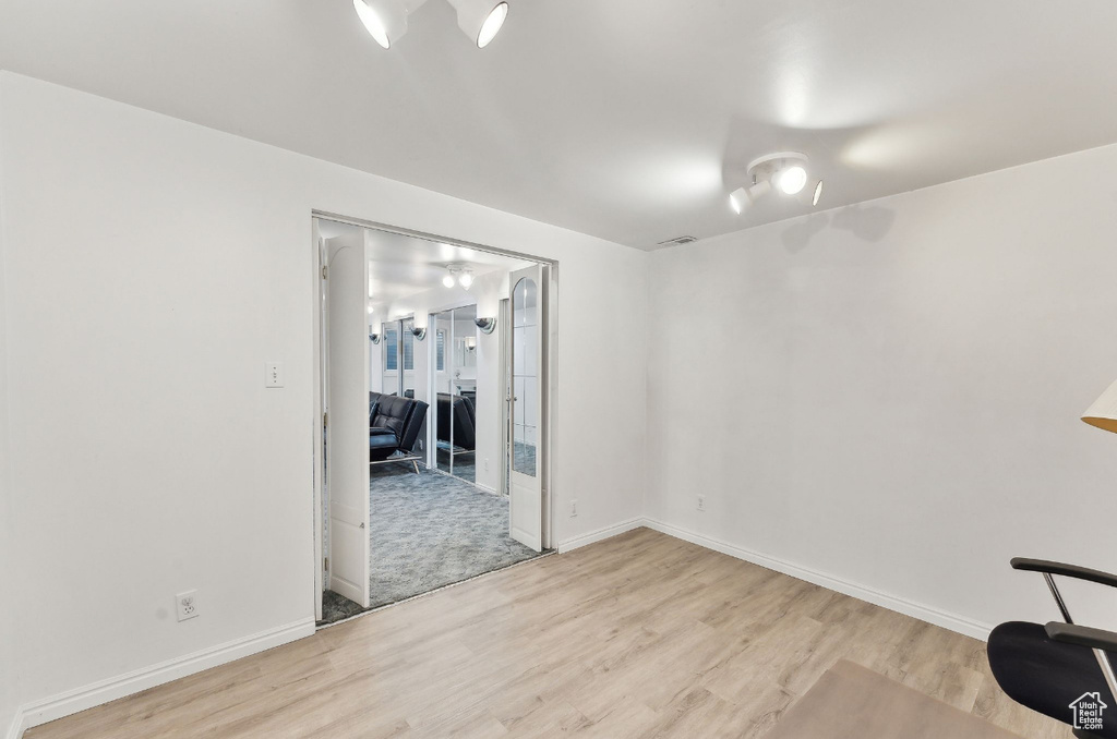 Empty room featuring wood finished floors and baseboards