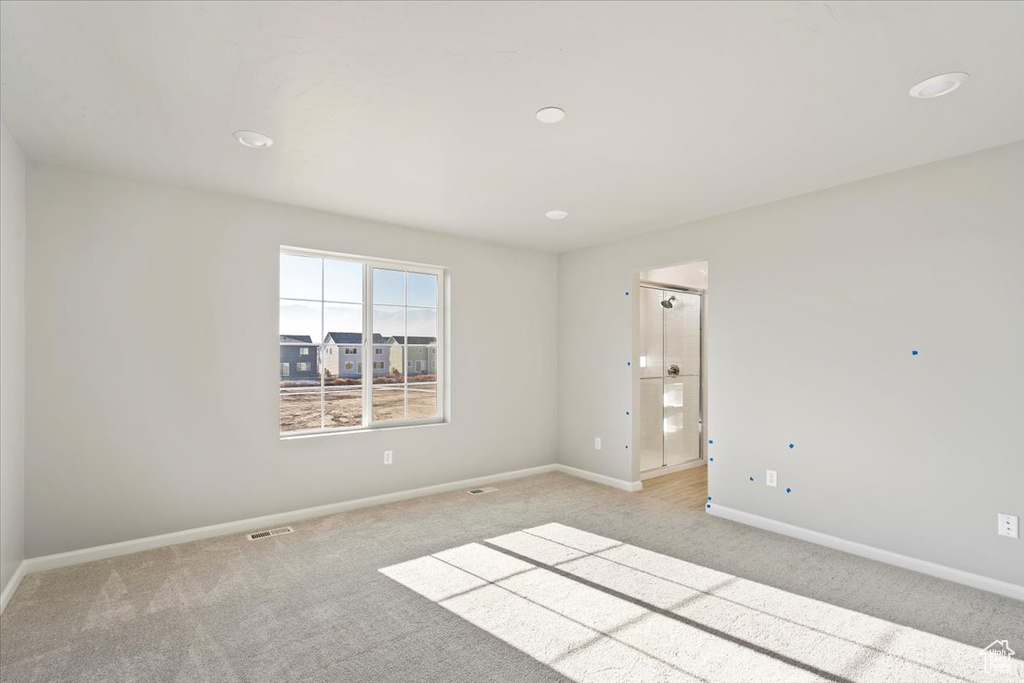 Unfurnished room featuring light colored carpet, baseboards, and recessed lighting