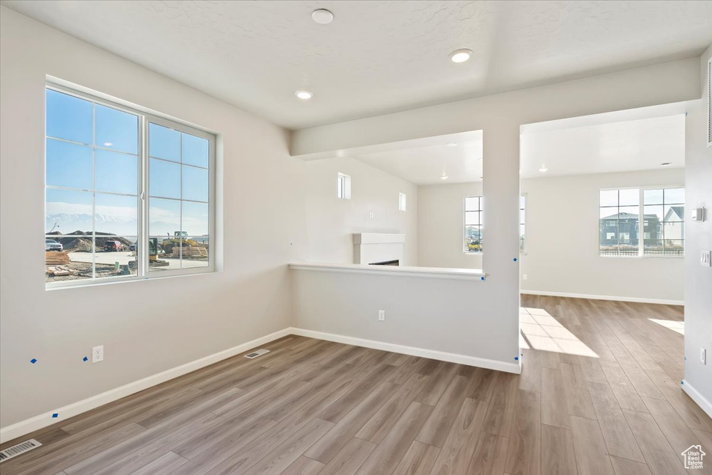 Spare room featuring wood finished floors, baseboards, and recessed lighting