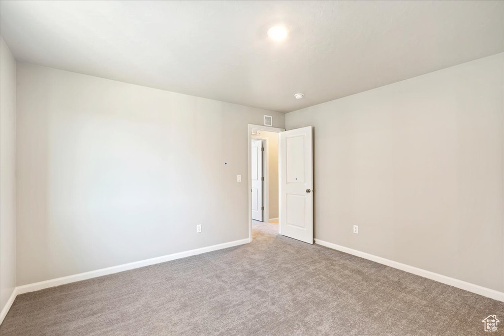 Spare room with carpet floors and baseboards