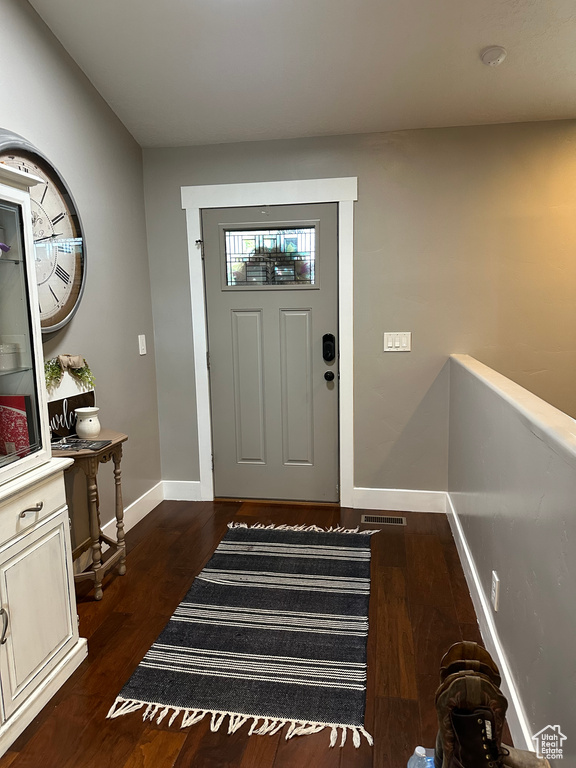 Entrance foyer with dark hardwood / wood-style floors
