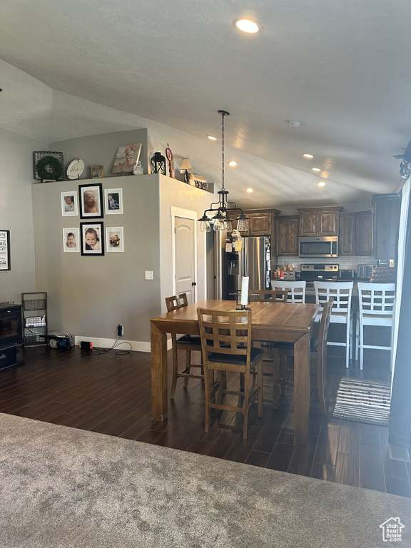 Dining space featuring dark wood-style flooring, a chandelier, recessed lighting, and baseboards