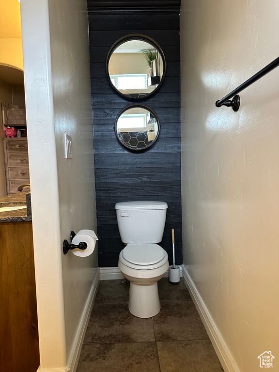 Bathroom featuring sink, toilet, and tile floors