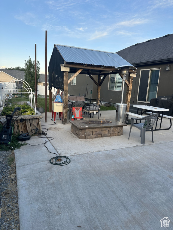 View of patio / terrace featuring a fire pit and a gazebo