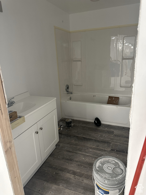 Bathroom with vanity, wood finished floors, and shower / bath combination