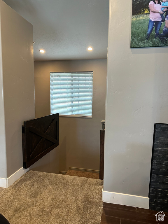 Staircase with dark colored carpet