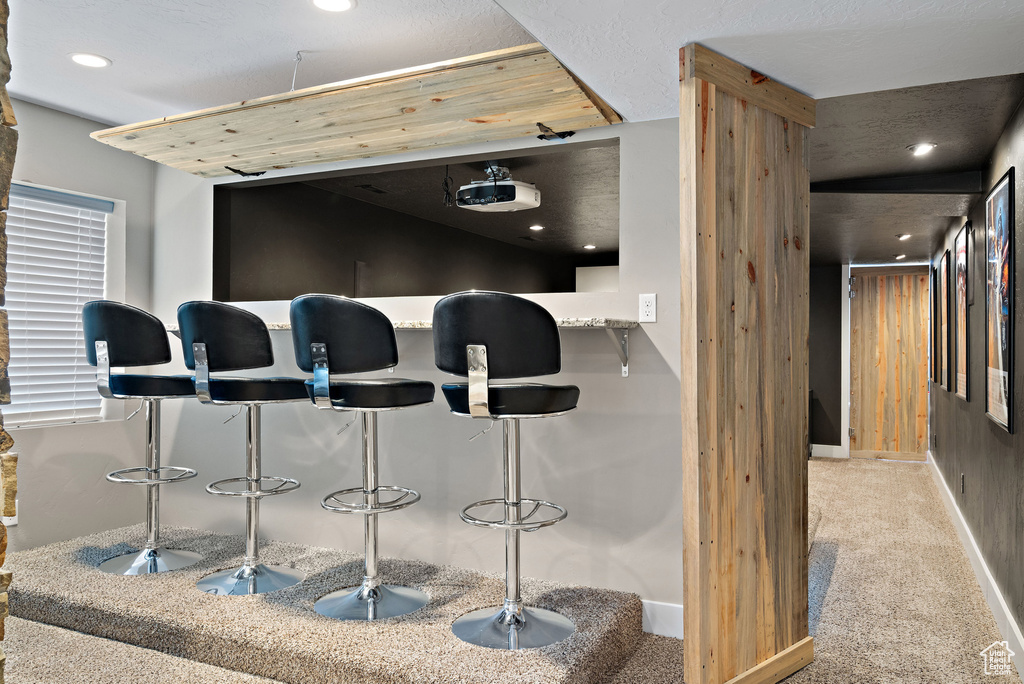 Bar featuring carpet, recessed lighting, and baseboards