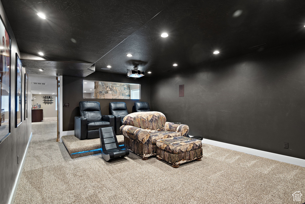 Home theater room featuring carpet, baseboards, and recessed lighting