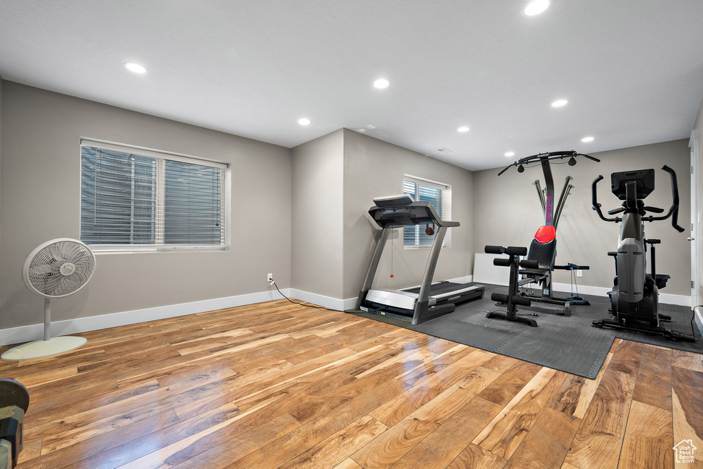 Exercise room featuring wood finished floors, recessed lighting, and baseboards