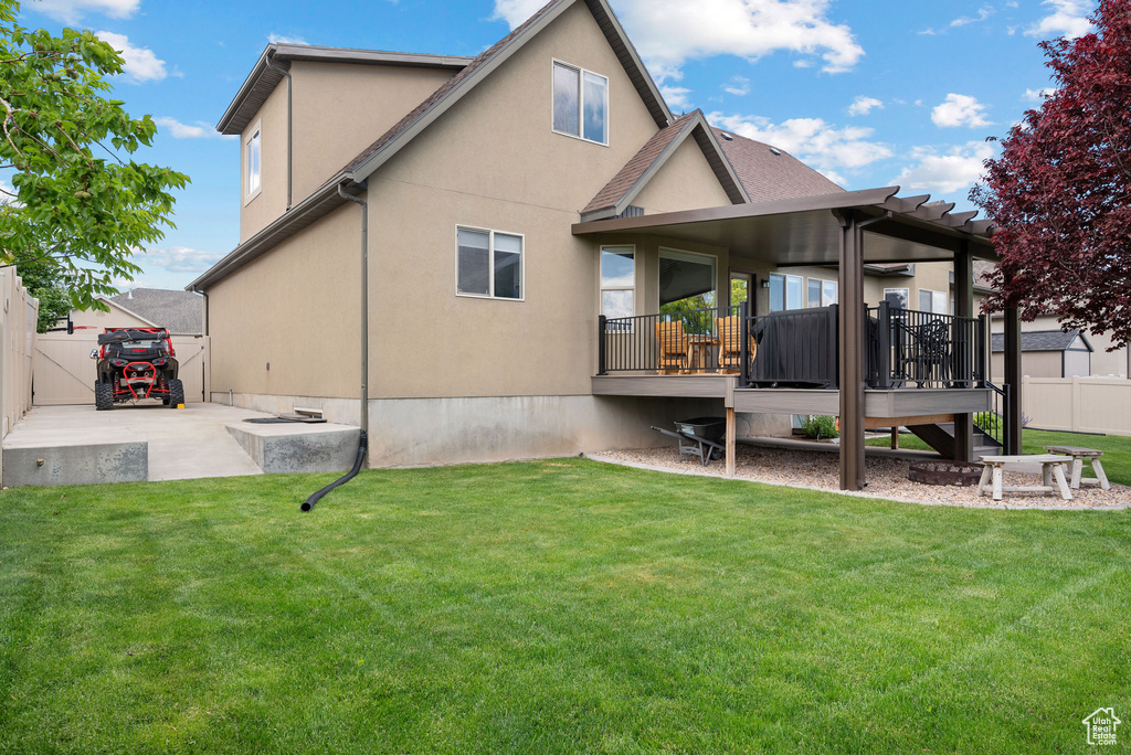 Back of property featuring a deck and stucco siding