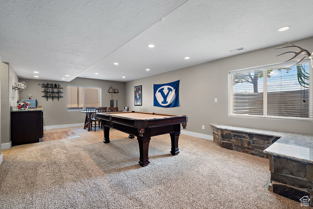 Game room with light colored carpet, a textured ceiling, pool table, recessed lighting, and baseboards