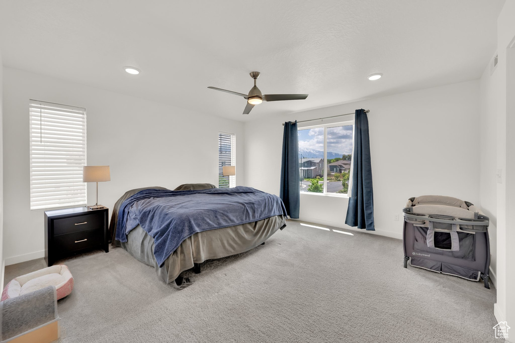 Carpeted bedroom with baseboards, a ceiling fan, and recessed lighting