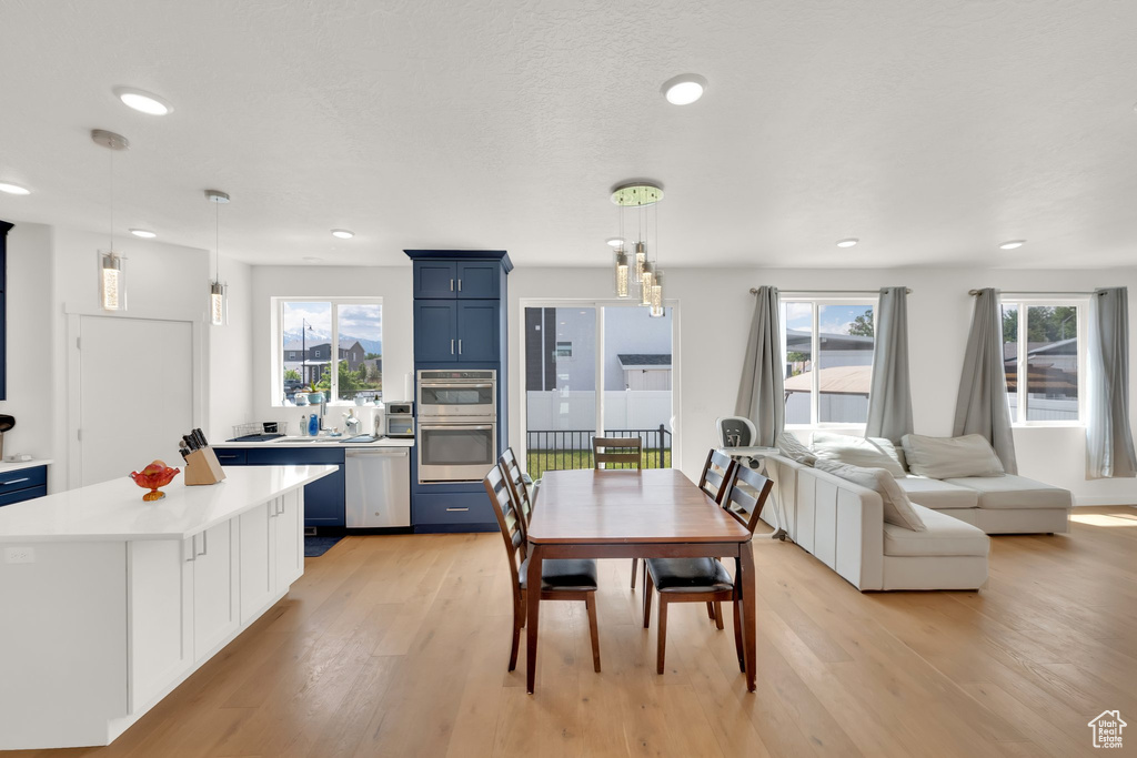 Dining space with light wood-type flooring, recessed lighting, and healthy amount of natural light