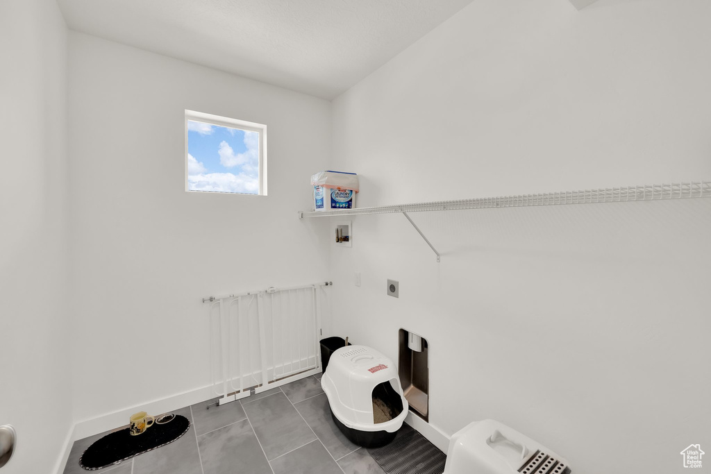 Laundry room featuring hookup for a washing machine, electric dryer hookup, and baseboards