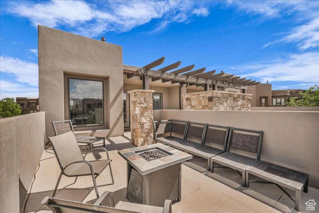 View of patio / terrace with a pergola and an outdoor living space with a fire pit