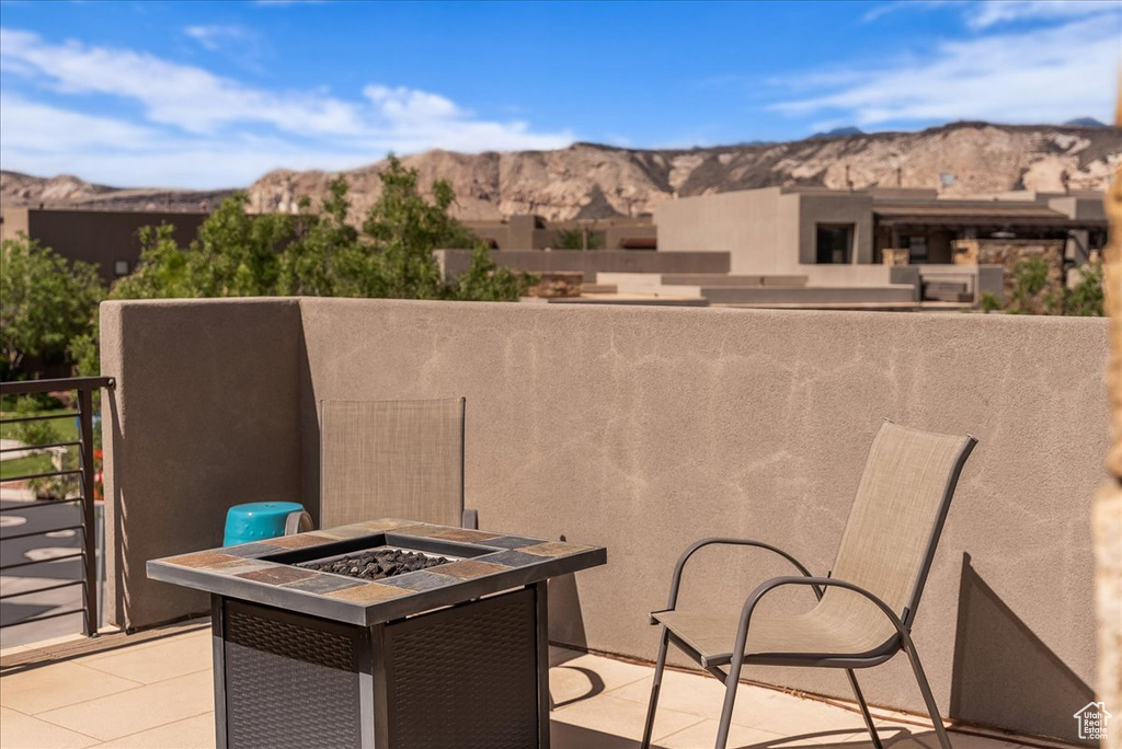 View of patio with an outdoor fire pit and a mountain view