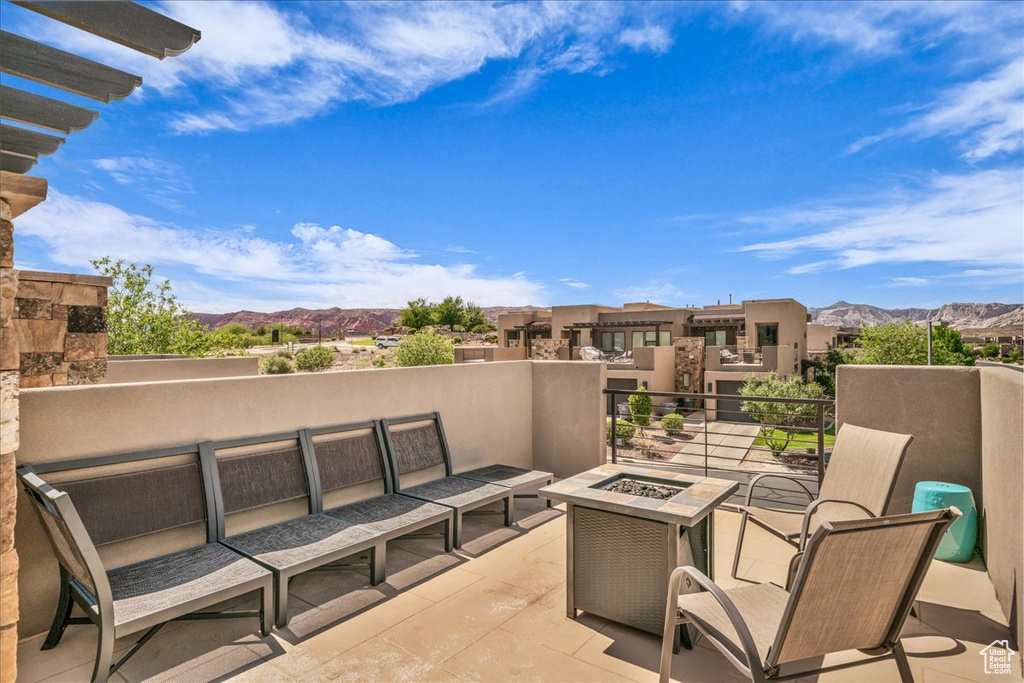 View of patio featuring a mountain view and an outdoor living space with a fire pit