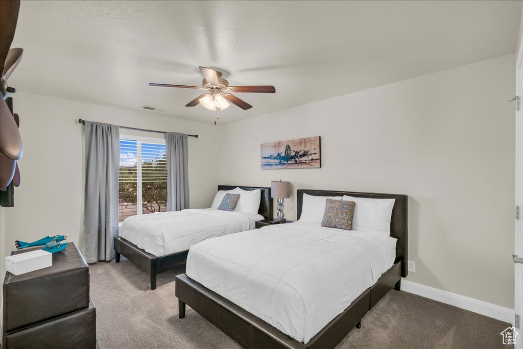 Bedroom featuring carpet flooring, baseboards, and a ceiling fan