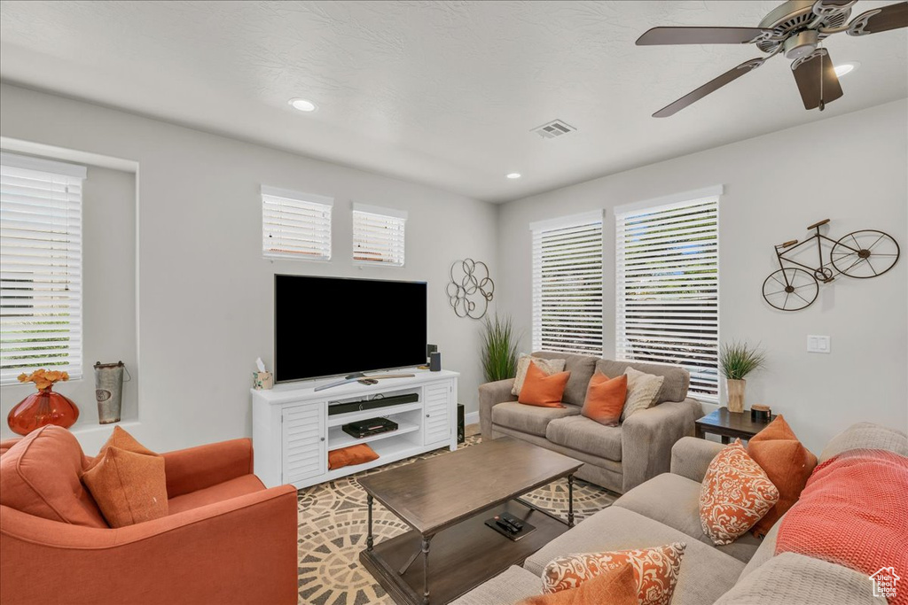 Living area with a ceiling fan and recessed lighting