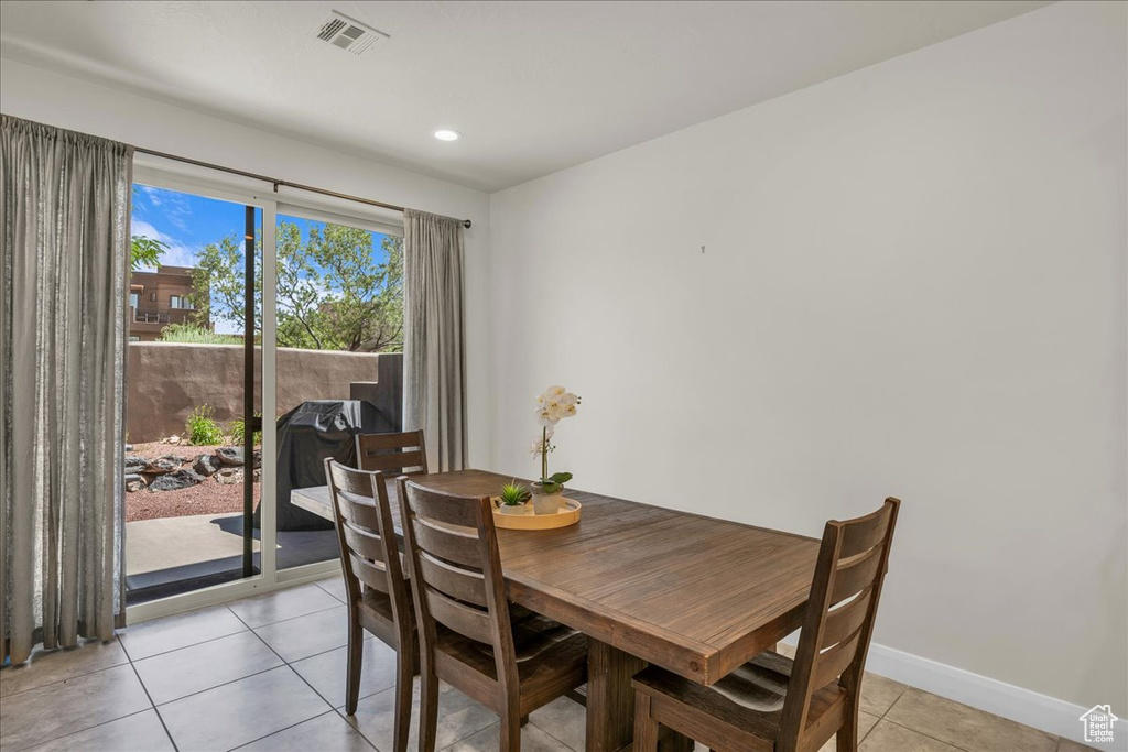 Dining space featuring light tile patterned flooring, baseboards, and recessed lighting